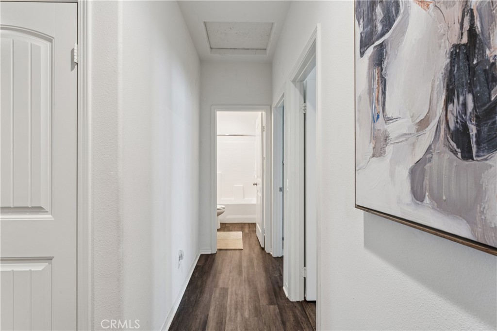 30535 Ridgely Way Menifee, CA 92584 - Photo 7 of 37 a view of a hallway with wooden floor and staircase