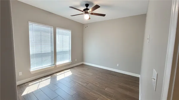 a bathroom with a granite countertop sink a mirror and shower
