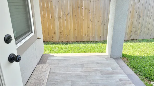 a view of swimming pool with lawn chairs and plants