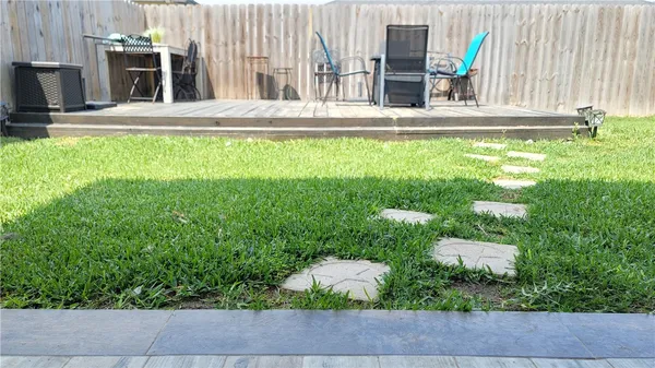 a view of a house with backyard porch and sitting area