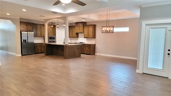 a large kitchen with lots of counter space cabinets and stainless steel appliances