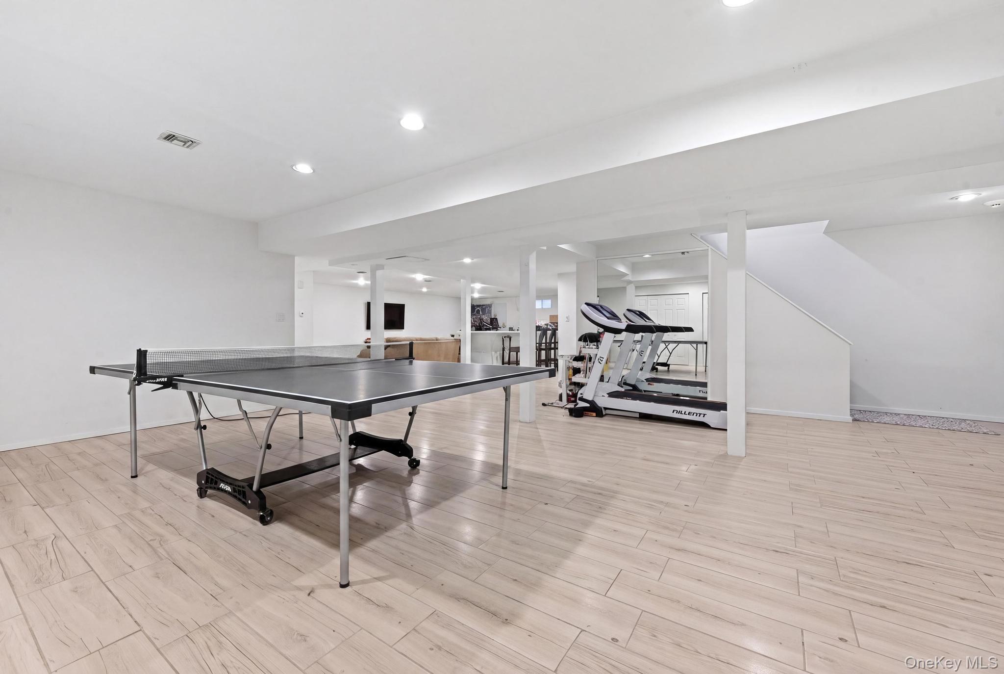 19 Sunset Road West Albertson, NY 11507 - Photo 23 of 24 Spacious lower level featuring wood-finish flooring, recessed lighting, and white painted walls