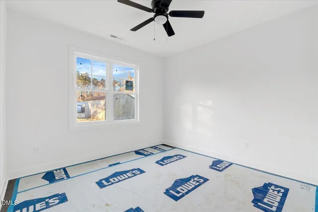 a view of a workspace with furniture and window