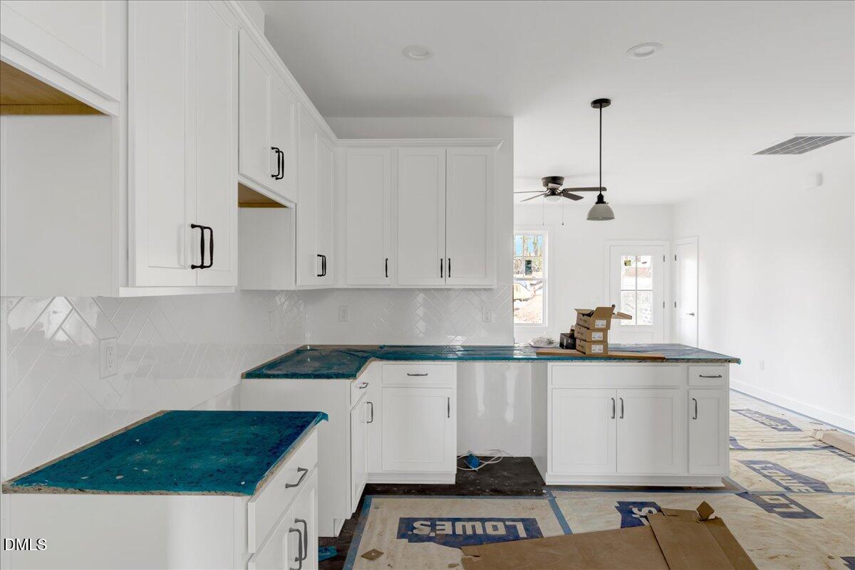 207 Terrell Street Norlina, NC 27563 - Photo 6 of 23 a kitchen with granite countertop a sink a stove and cabinets