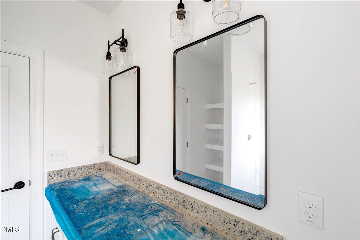 207 Terrell Street Norlina, NC 27563 - Photo 10 of 23 a view of a hallway with wooden floor and a bathroom