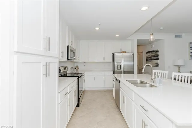 a kitchen with stainless steel appliances granite countertop a sink and cabinets