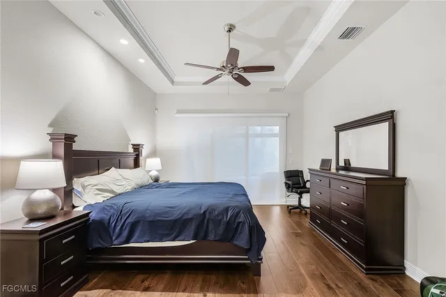 a bedroom with a bed and dresser with mirror