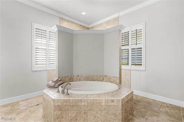 a bathroom with a granite countertop sink and a bathtub