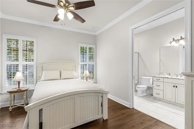 a spacious bedroom with a bed and a chandelier