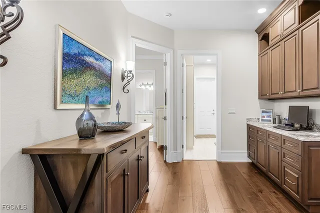 a kitchen with a sink cabinets and wooden floor