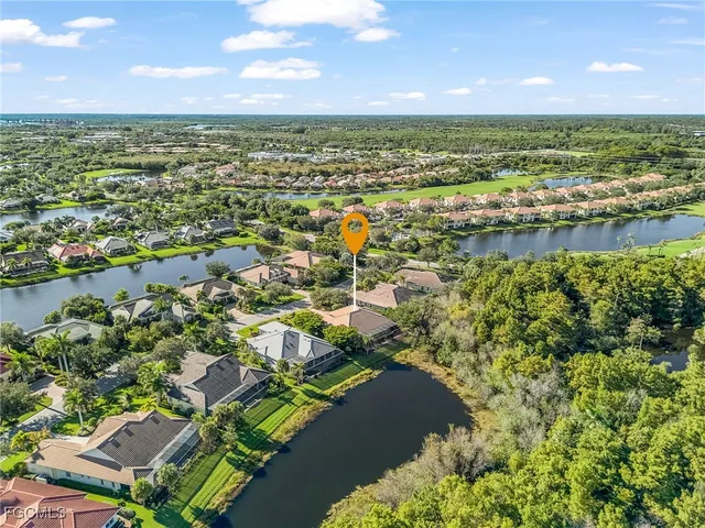 a view of a lake with houses in the background