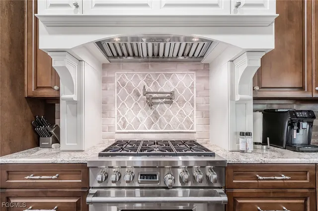 a stove top oven sitting inside of a kitchen