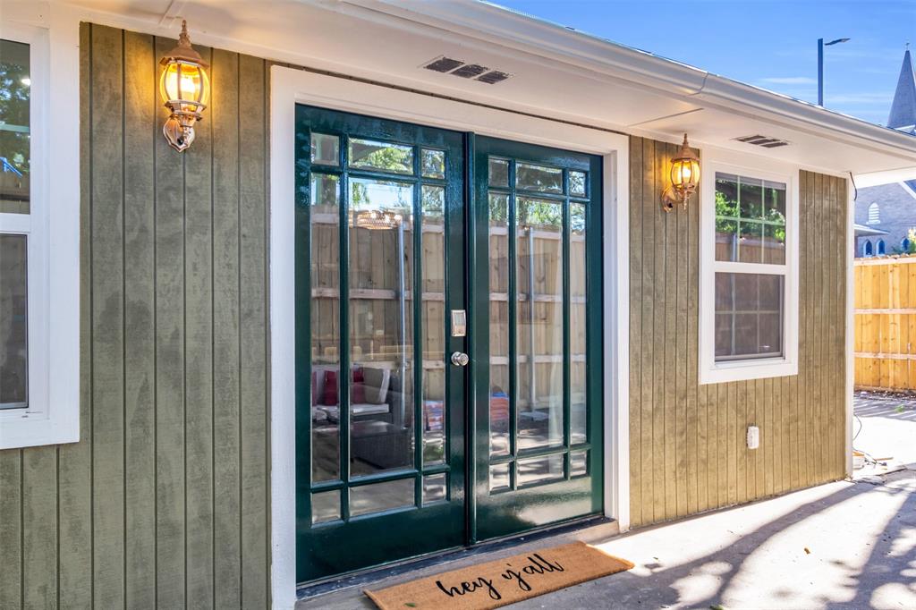 4121 Junius Street, Unit B Dallas, TX 75246 - Photo 1 of 32 French-pane double doors with dark green frames