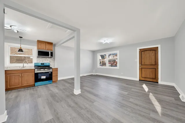 a view of kitchen with sink and wooden floor