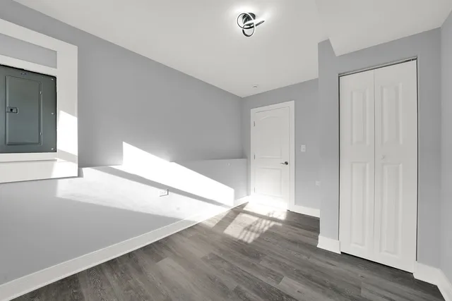 a view of an empty room with wooden floor