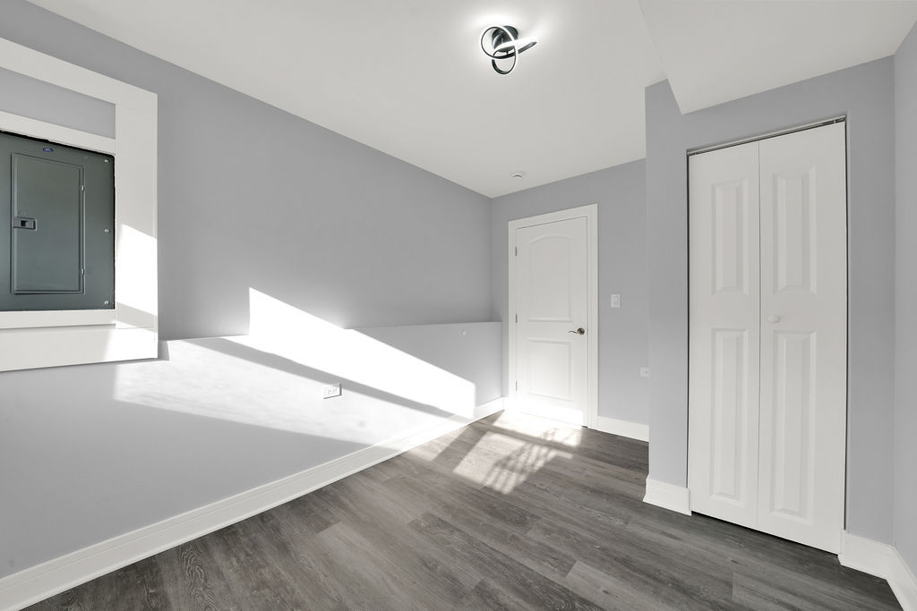 1275 West 71st Street Chicago, IL 60636 - Photo 12 of 21 a view of an empty room with wooden floor