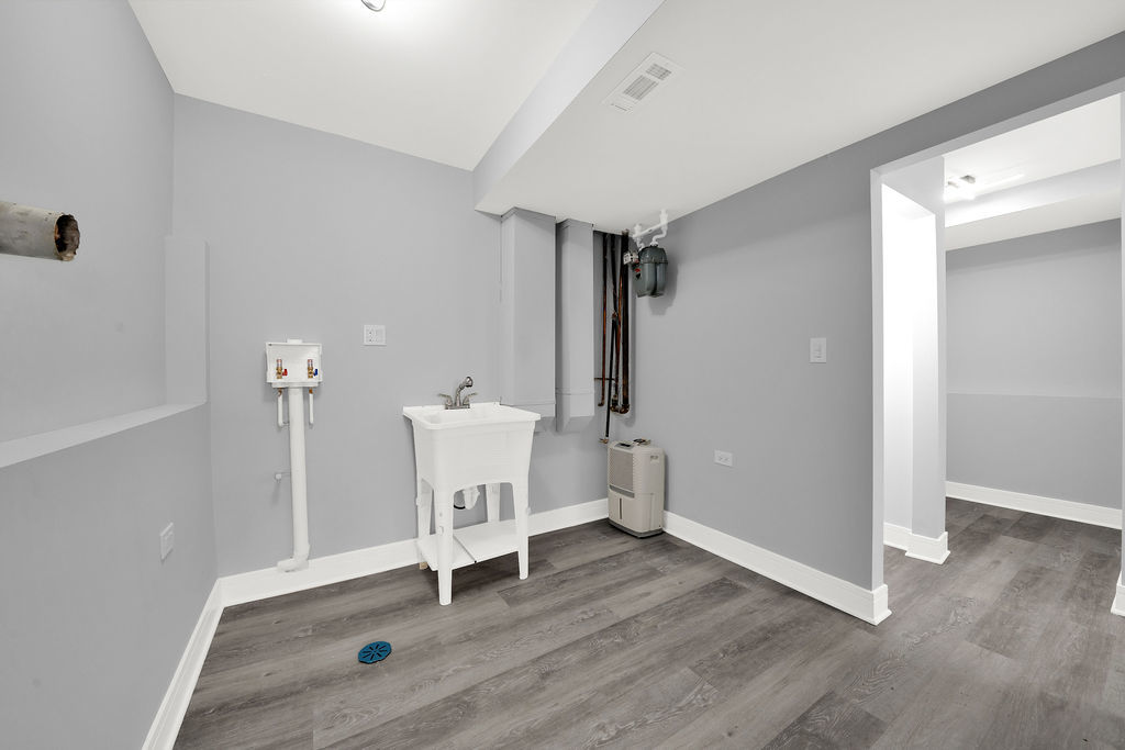 1275 West 71st Street Chicago, IL 60636 - Photo 14 of 21 an empty room with wooden floor and windows