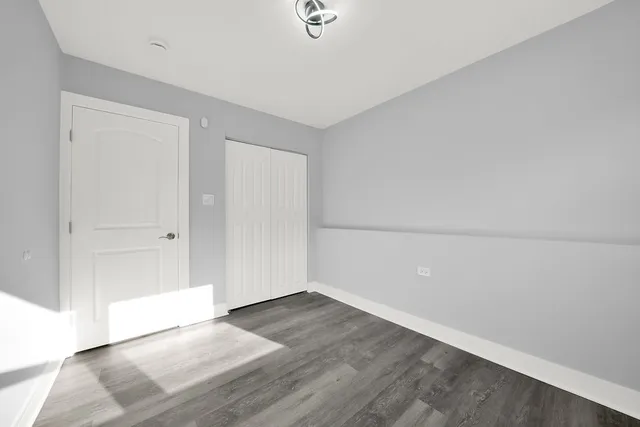 an empty room with wooden floor