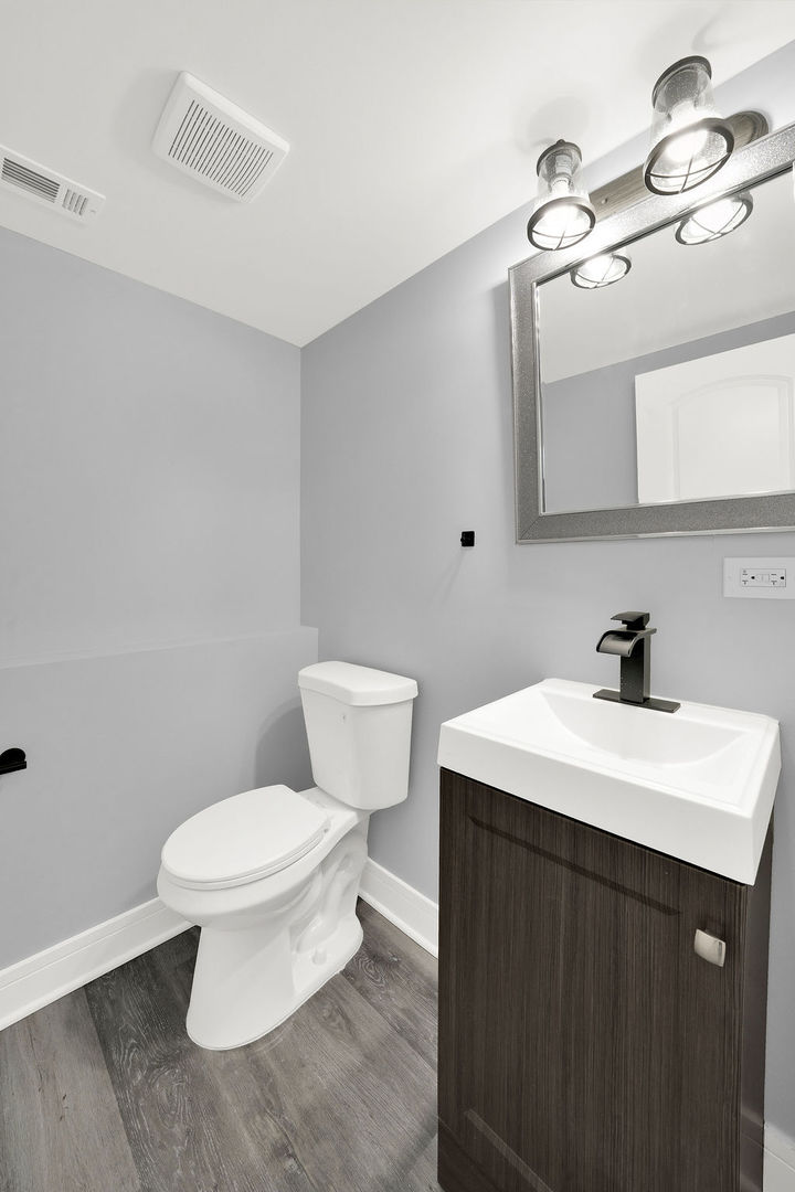 1275 West 71st Street Chicago, IL 60636 - Photo 17 of 21 a bathroom with a sink a toilet and mirror