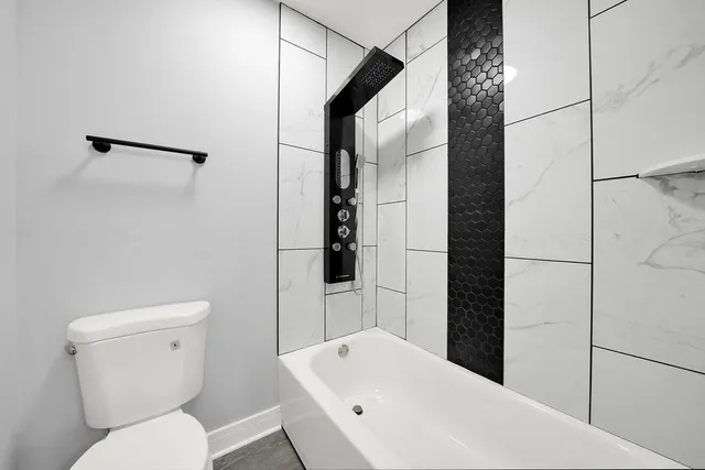 a bathroom with a toilet a sink and shower