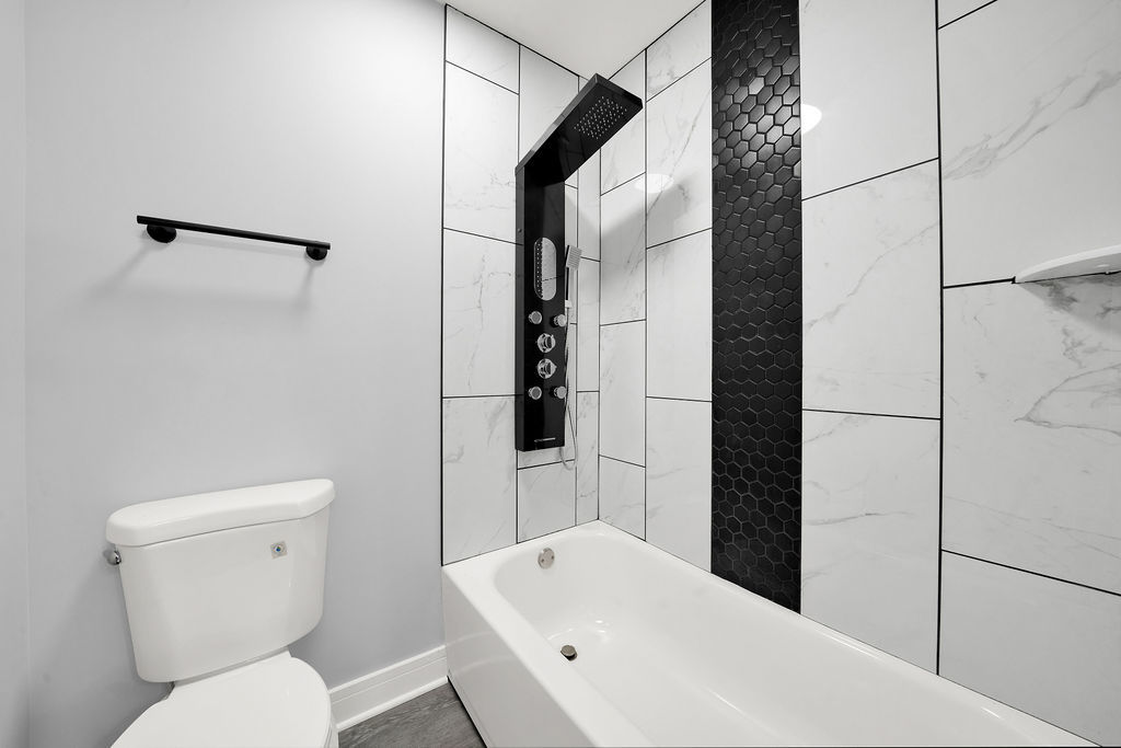 1275 West 71st Street Chicago, IL 60636 - Photo 21 of 21 a bathroom with a toilet a sink and shower