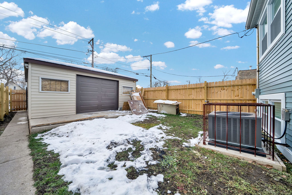 1275 West 71st Street Chicago, IL 60636 - Photo 6 of 21 a backyard of a house with a garden