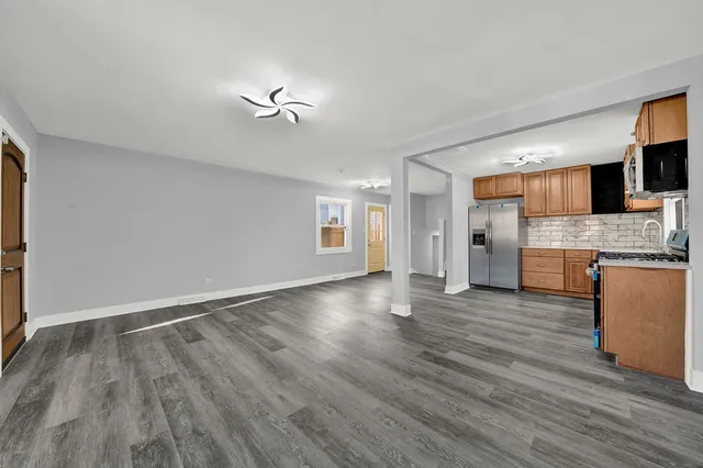 a view of a kitchen with a sink and a refrigerator
