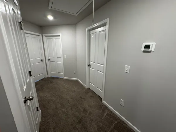 an empty room with a ceiling fan and a window