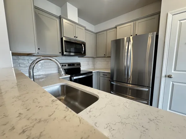 a kitchen with a sink stainless steel appliances and cabinets