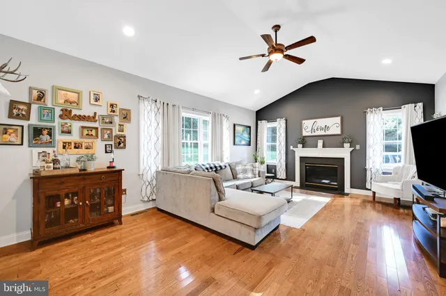 a living room with furniture fireplace and flat screen tv