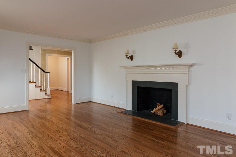 308 Buncombe Street Raleigh, NC 27609 - Photo 2 of 25 a living room with wooden floor and a fireplace