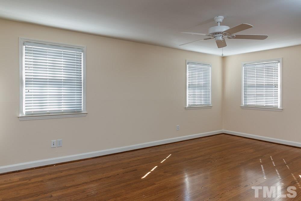308 Buncombe Street Raleigh, NC 27609 - Photo 16 of 25 a view of an empty room with wooden floor and a window