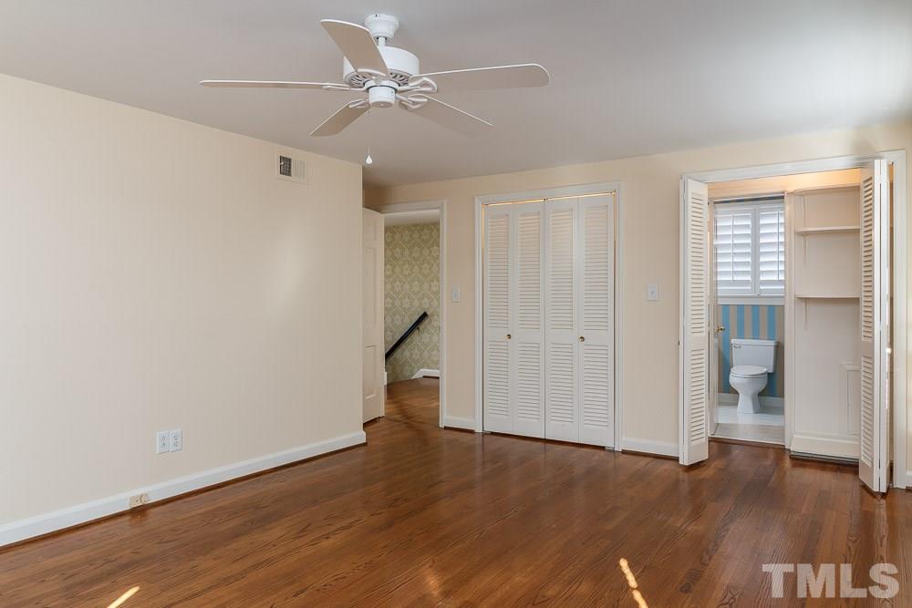 308 Buncombe Street Raleigh, NC 27609 - Photo 17 of 25 an empty room with wooden floor and windows