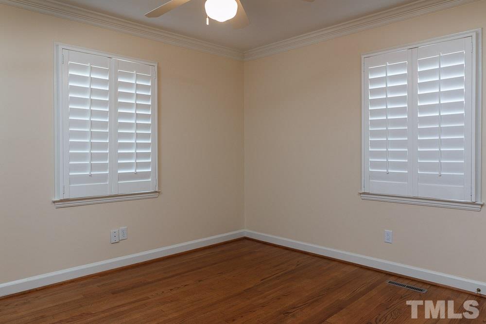 308 Buncombe Street Raleigh, NC 27609 - Photo 19 of 25 a view of an empty room with wooden floor and a window