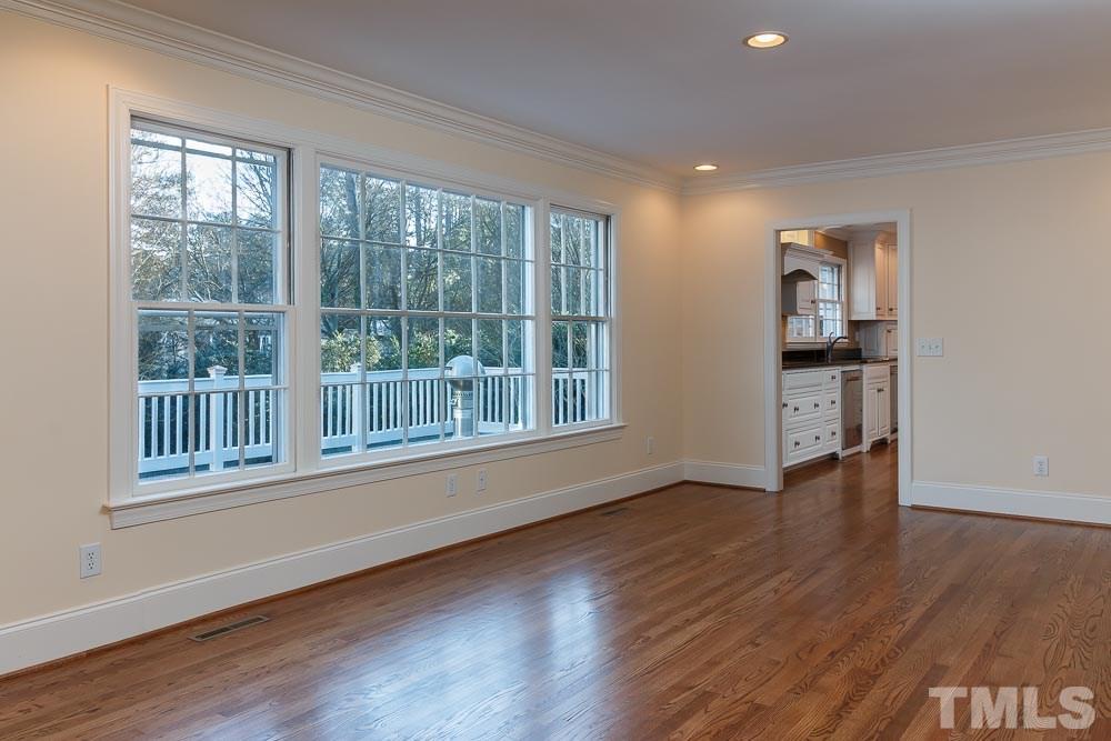 308 Buncombe Street Raleigh, NC 27609 - Photo 5 of 25 a view of an empty room with wooden floor and a window