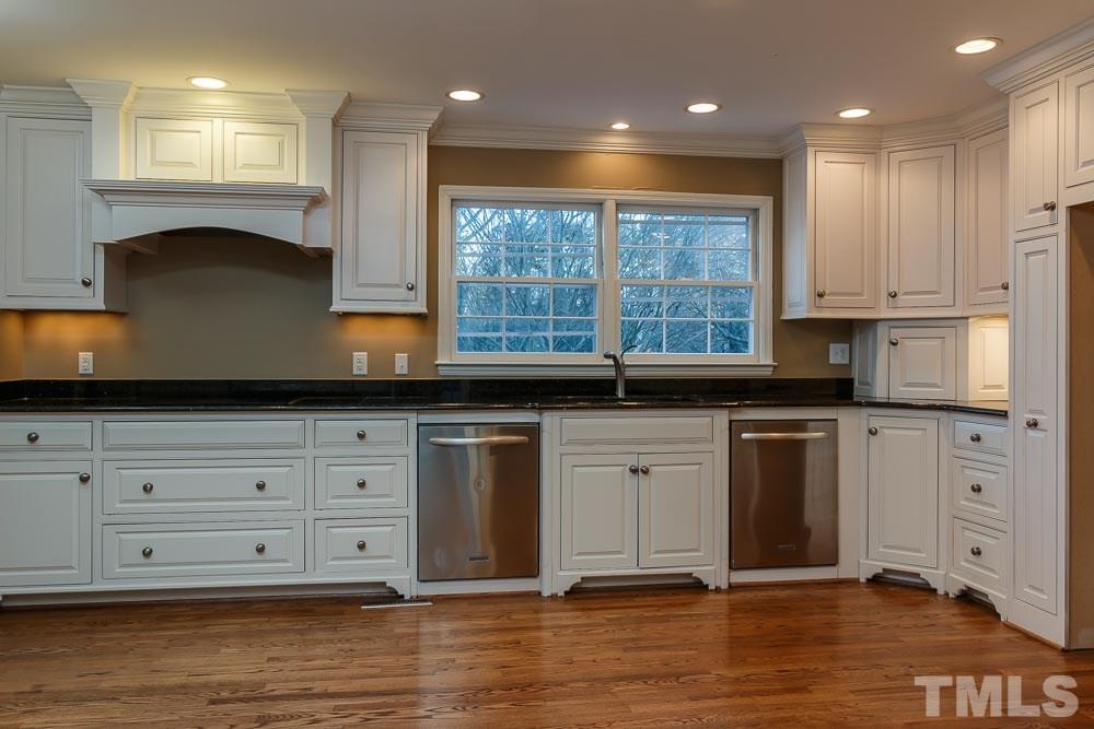 308 Buncombe Street Raleigh, NC 27609 - Photo 6 of 25 a kitchen with stainless steel appliances granite countertop a sink a stove and a refrigerator