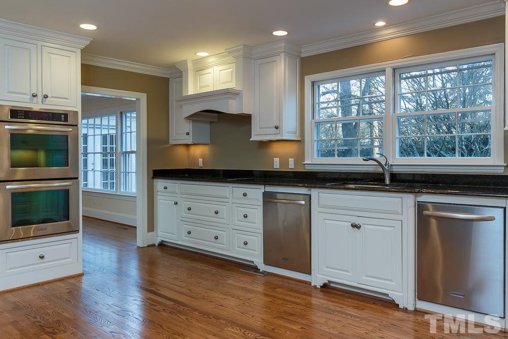 308 Buncombe Street Raleigh, NC 27609 - Photo 7 of 25 a kitchen with granite countertop a stove a sink and a microwave