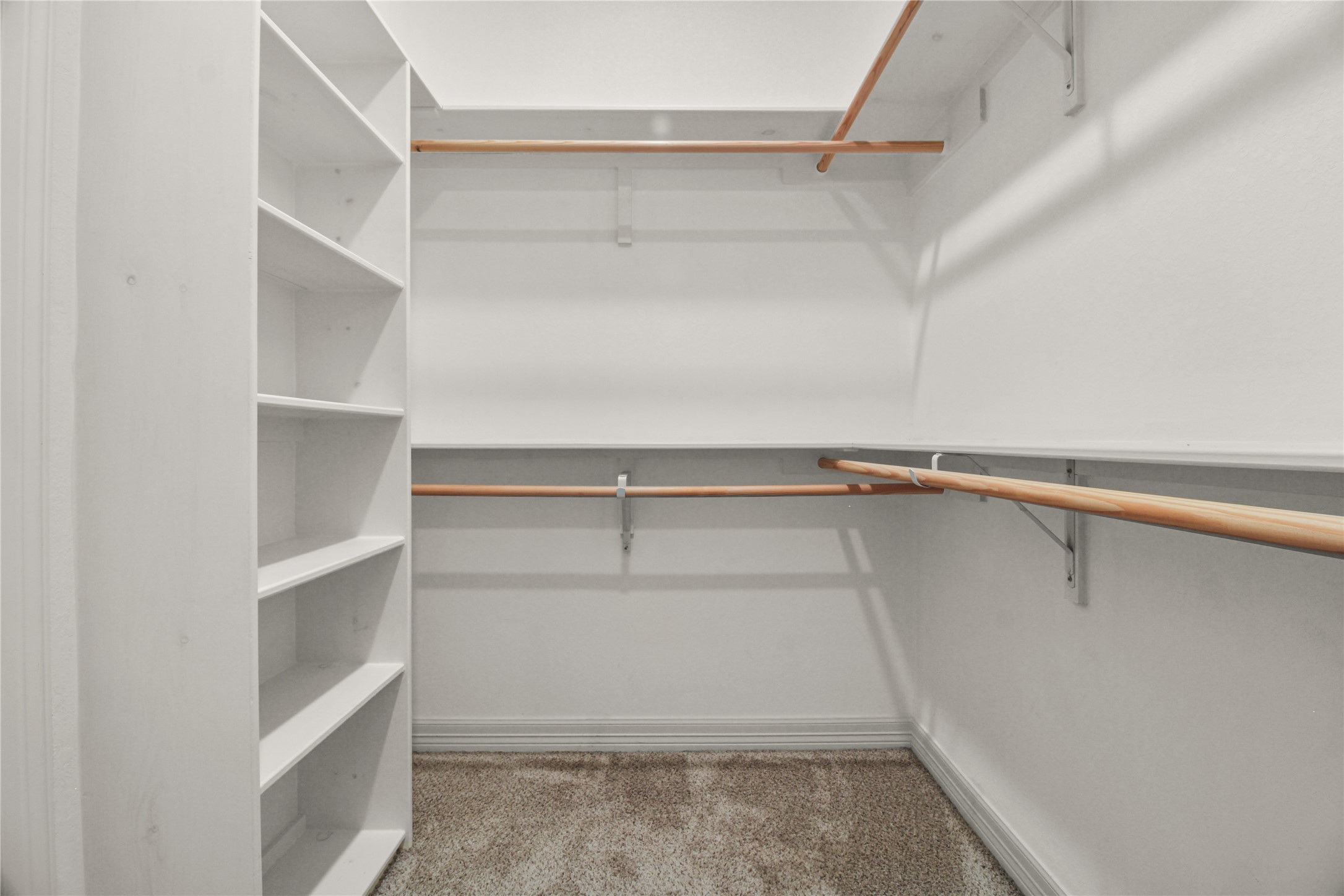 1208 East Henderson Road Angleton, TX 77515 - Photo 15 of 29 a view of walk in closet with empty racks