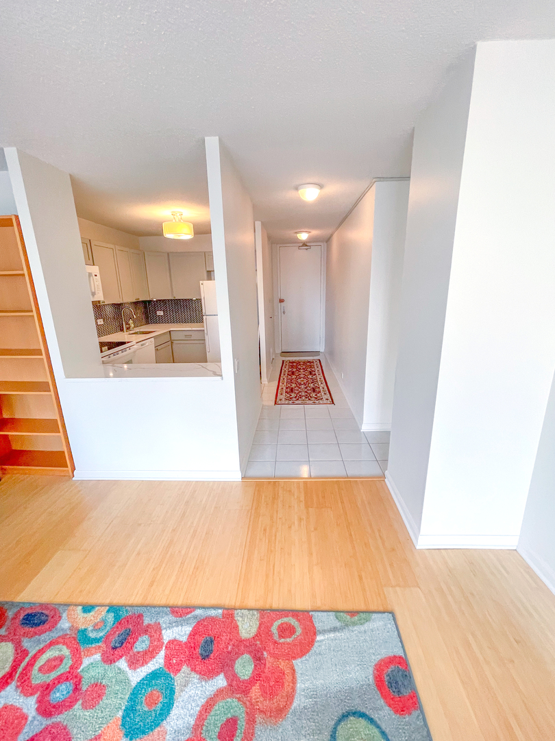 405 North Wabash Avenue, Unit 1410 Chicago, IL 60611 - Photo 7 of 18 a living room with a couch and a table