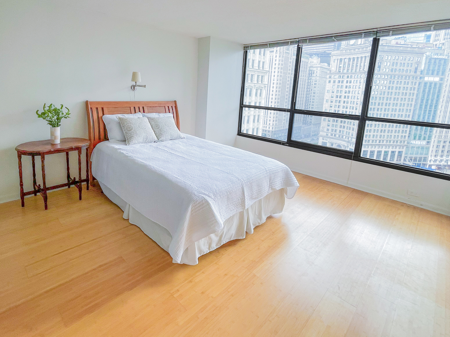 405 North Wabash Avenue, Unit 1410 Chicago, IL 60611 - Photo 8 of 18 a bed sitting in a bedroom next to a window