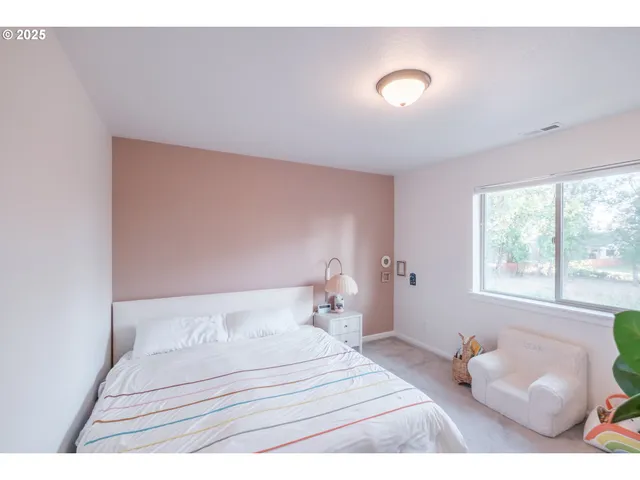 a bedroom with a bed and a white couch