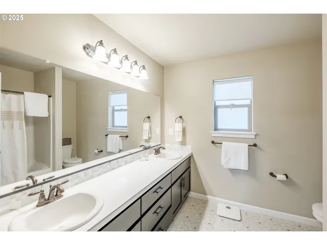 a bathroom with a sink vanity and a mirror