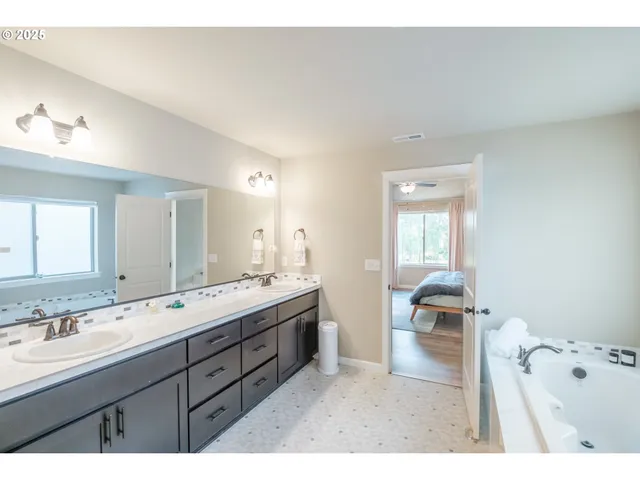 a bathroom with a granite countertop sink mirror and shower