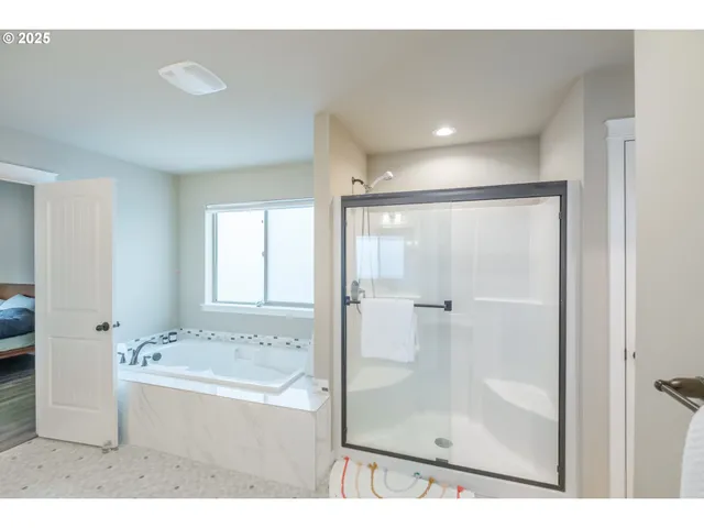 a bathroom with a bathtub and a window