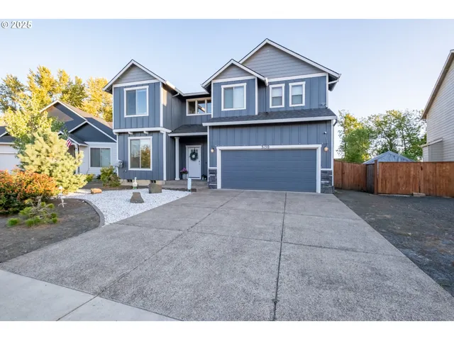 a front view of a house with yard and parking