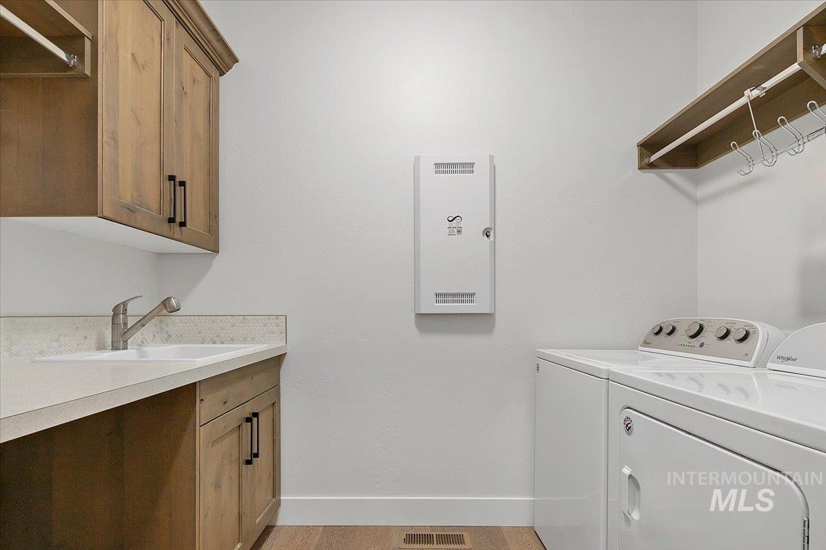 1685 Shoal Point Avenue Middleton, ID 83644 - Photo 13 of 44 Laundry area featuring washer and dryer and baseboards