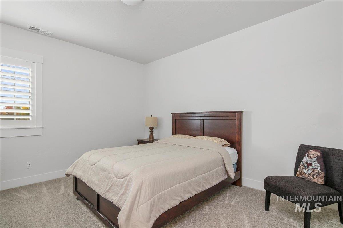 1685 Shoal Point Avenue Middleton, ID 83644 - Photo 33 of 44 Bedroom featuring light colored carpet and baseboards