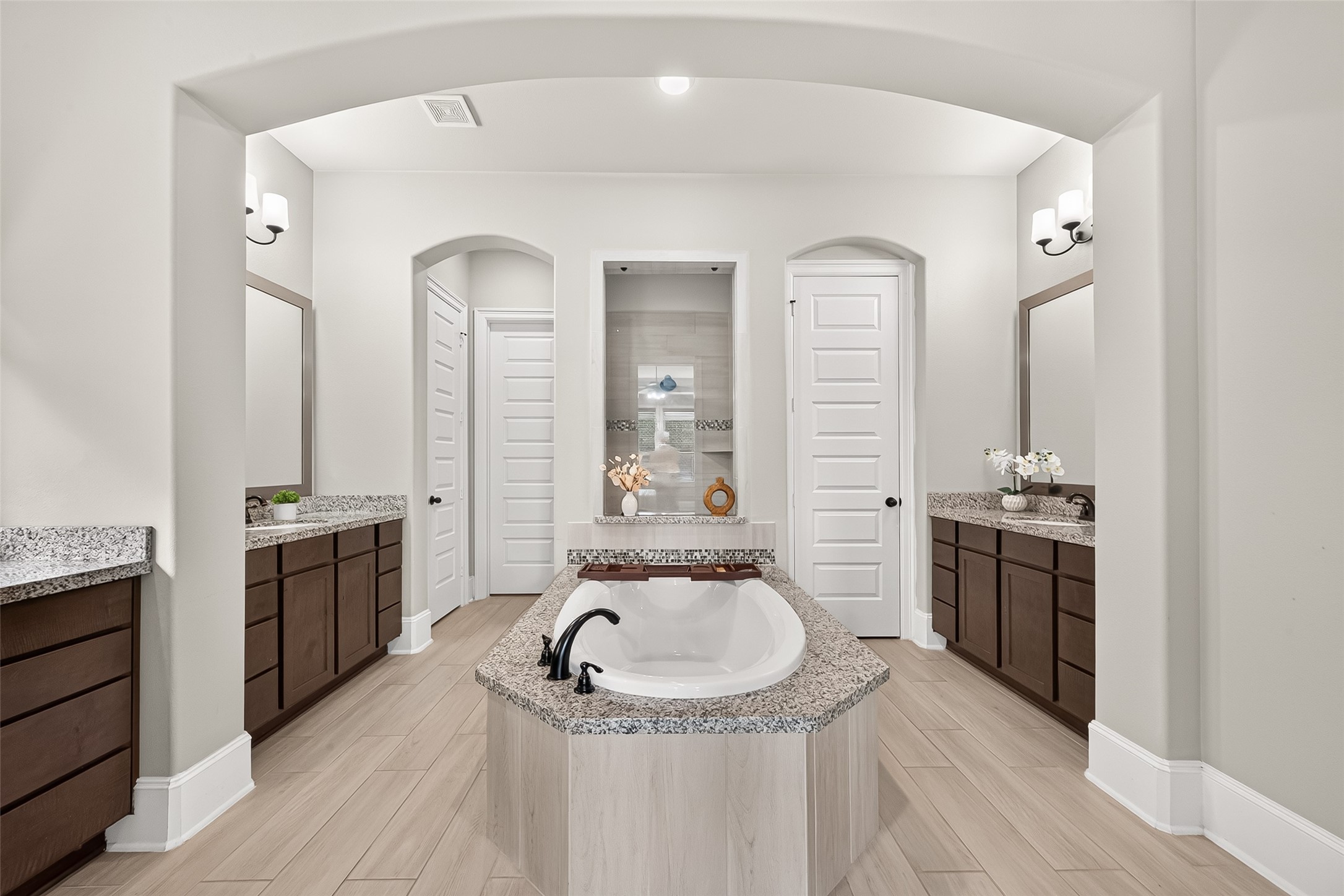 4207 Reagan Ridge Court Richmond, TX 77406 - Photo 32 of 50 Modern en-suite bath featuring a relaxing soaking tub, glass-enclosed shower, and dual vanities, creating a luxurious and spa-like retreat