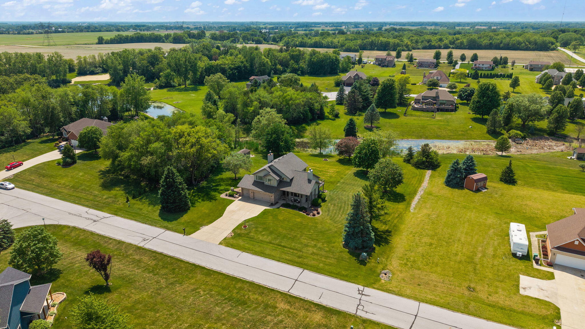 16368 Madison Street Lowell, IN 46356 - Photo 36 of 42 an aerial view of a house with a garden and lake view
