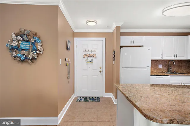 a kitchen with a refrigerator and a stove top oven